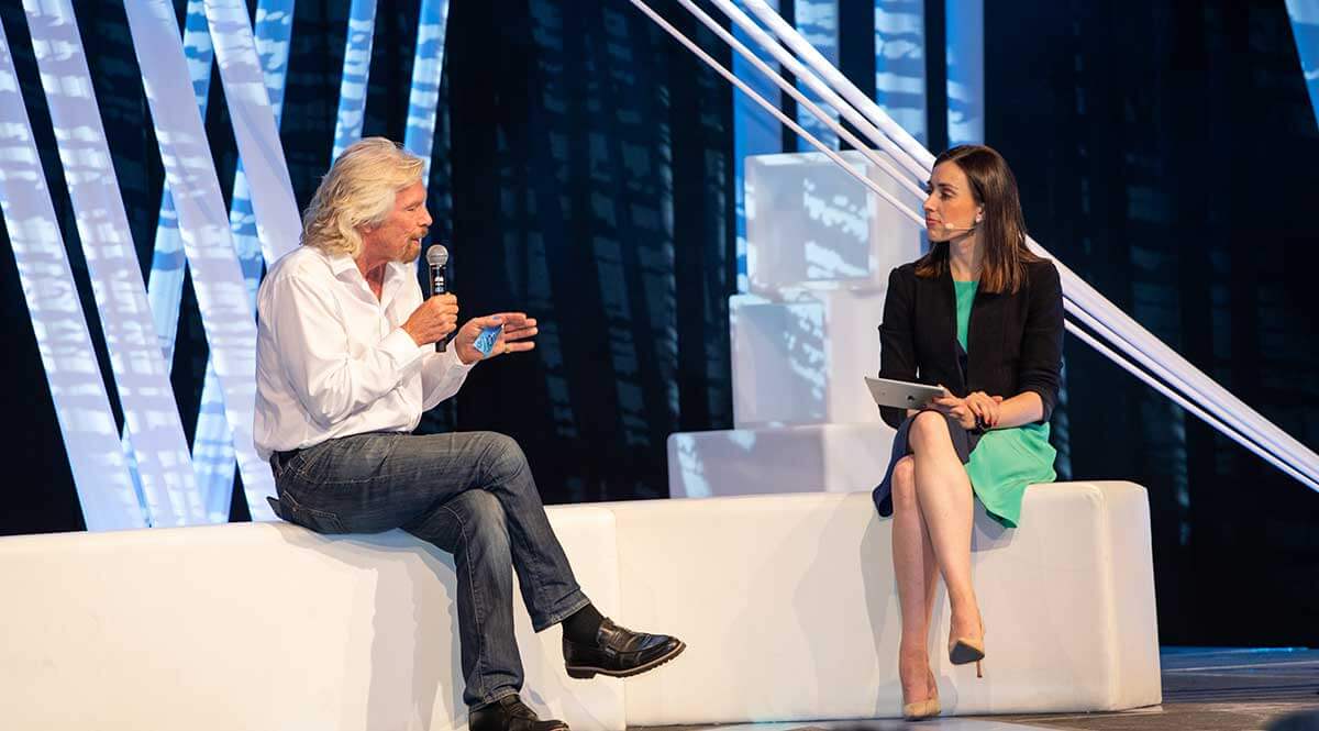 Holly Ransom interviewing Richard Branson on stage