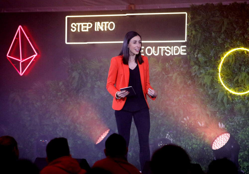Holly Ransom, global speaker on stage at an immersive event