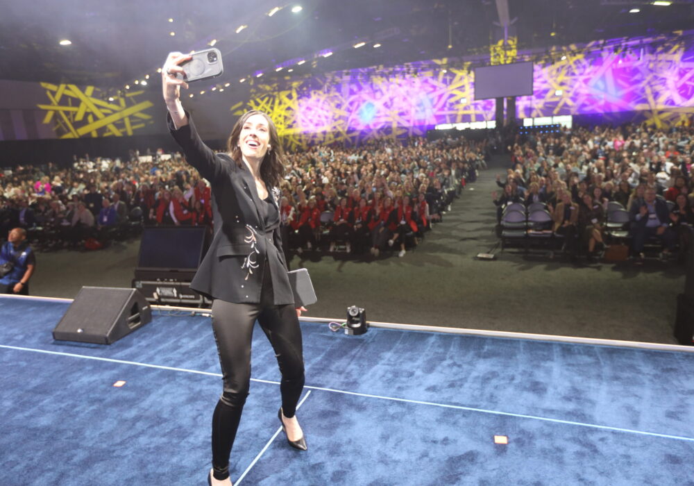 Holly Ransom in front of a large stage at the PCMA conference in 2024